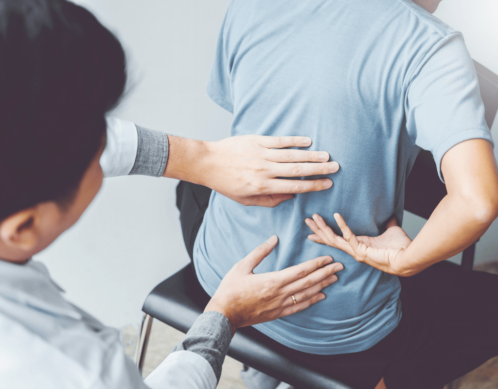 Therapist supporting a mans arm and examining his elbow and forearm