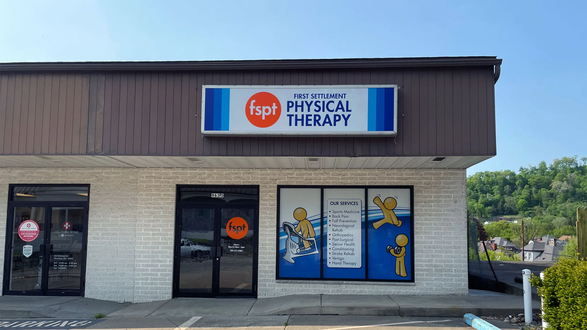 Strip-center unit with a blue First Settlement Physical Therapy sign and blue window decals